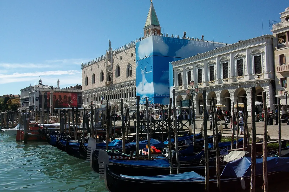 The side of the New Prisons beside the Rio di Palazzo with gondolas moored along the canal.